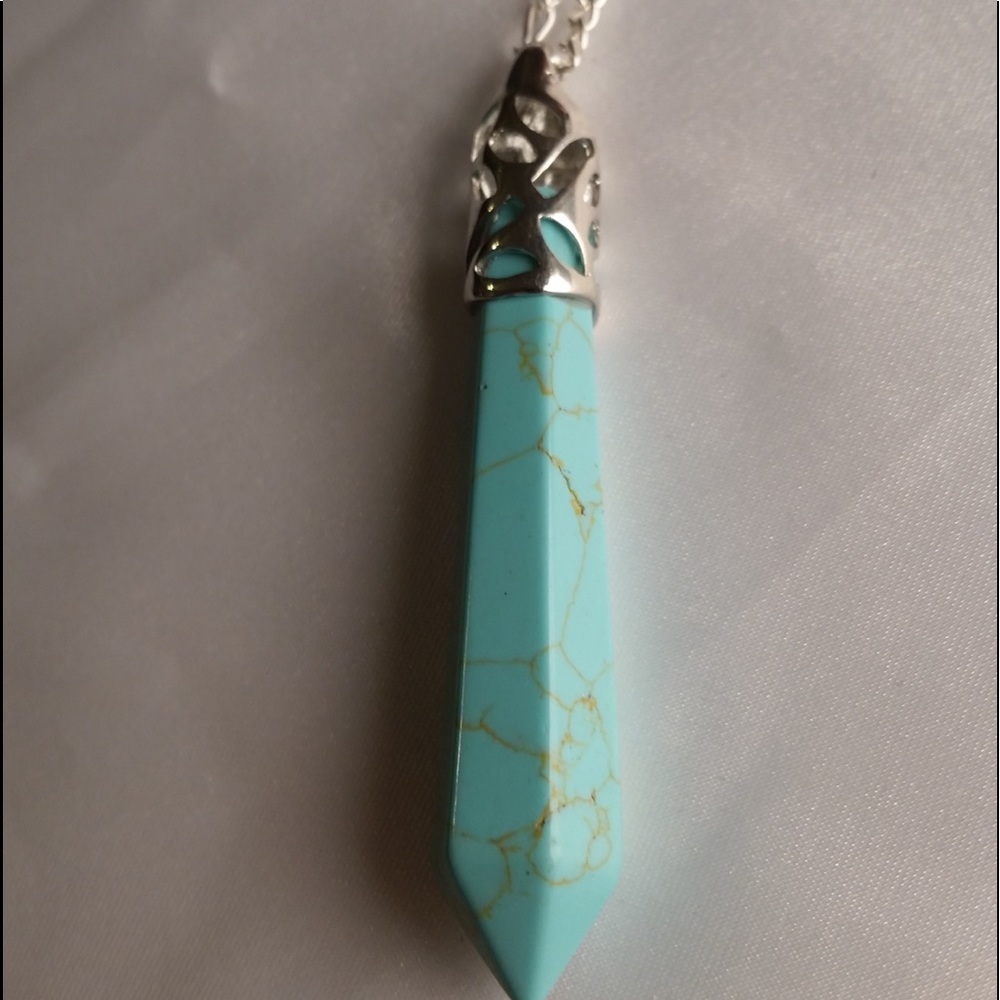 Turquoise and silver pointy pendant in a chain.